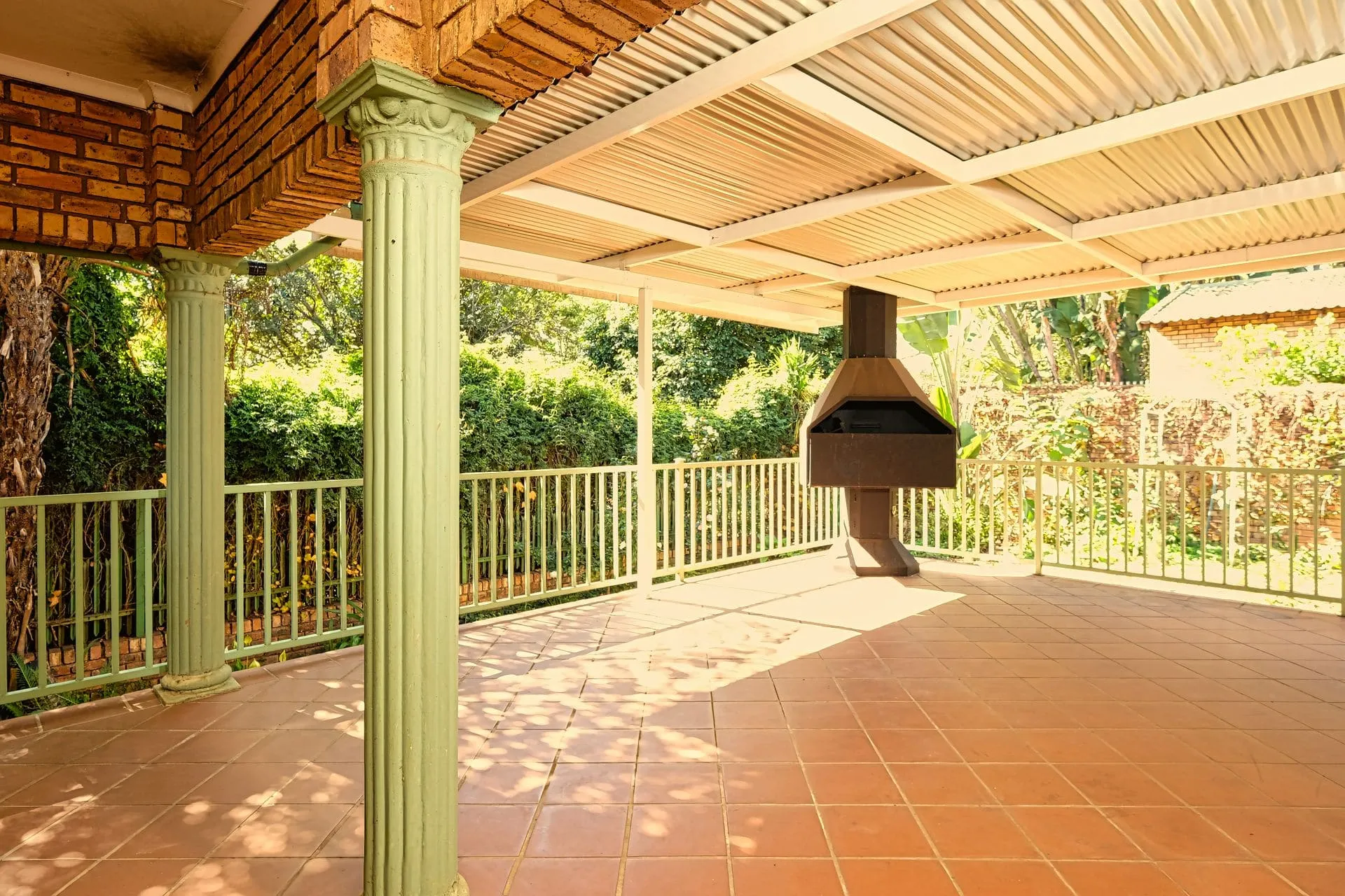 Roofed verandah with timber posts over a tiled outdoor area, subject to verandah council approval