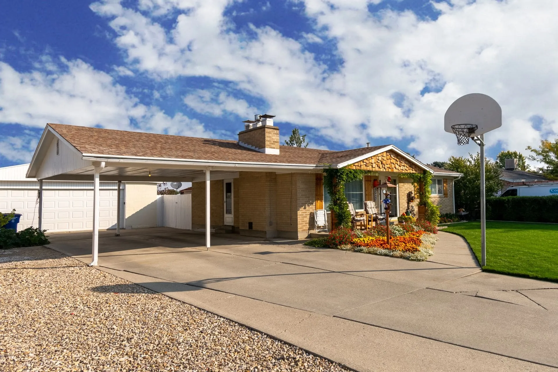 Single-storey home with an open carport beside the garage, comparing carport vs garage