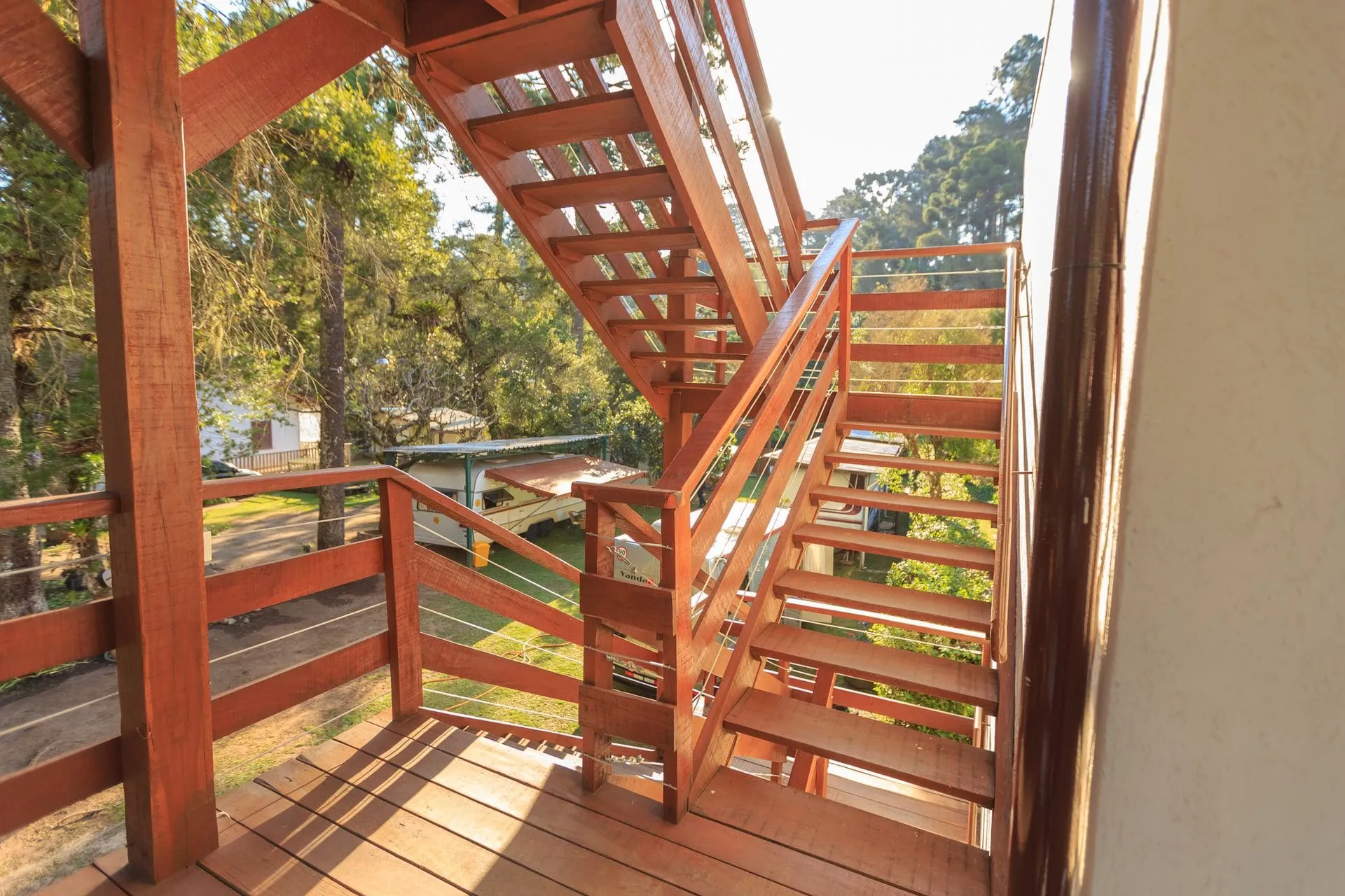 Timber deck stairs with a matching deck balustrade leading up to a raised outdoor deck