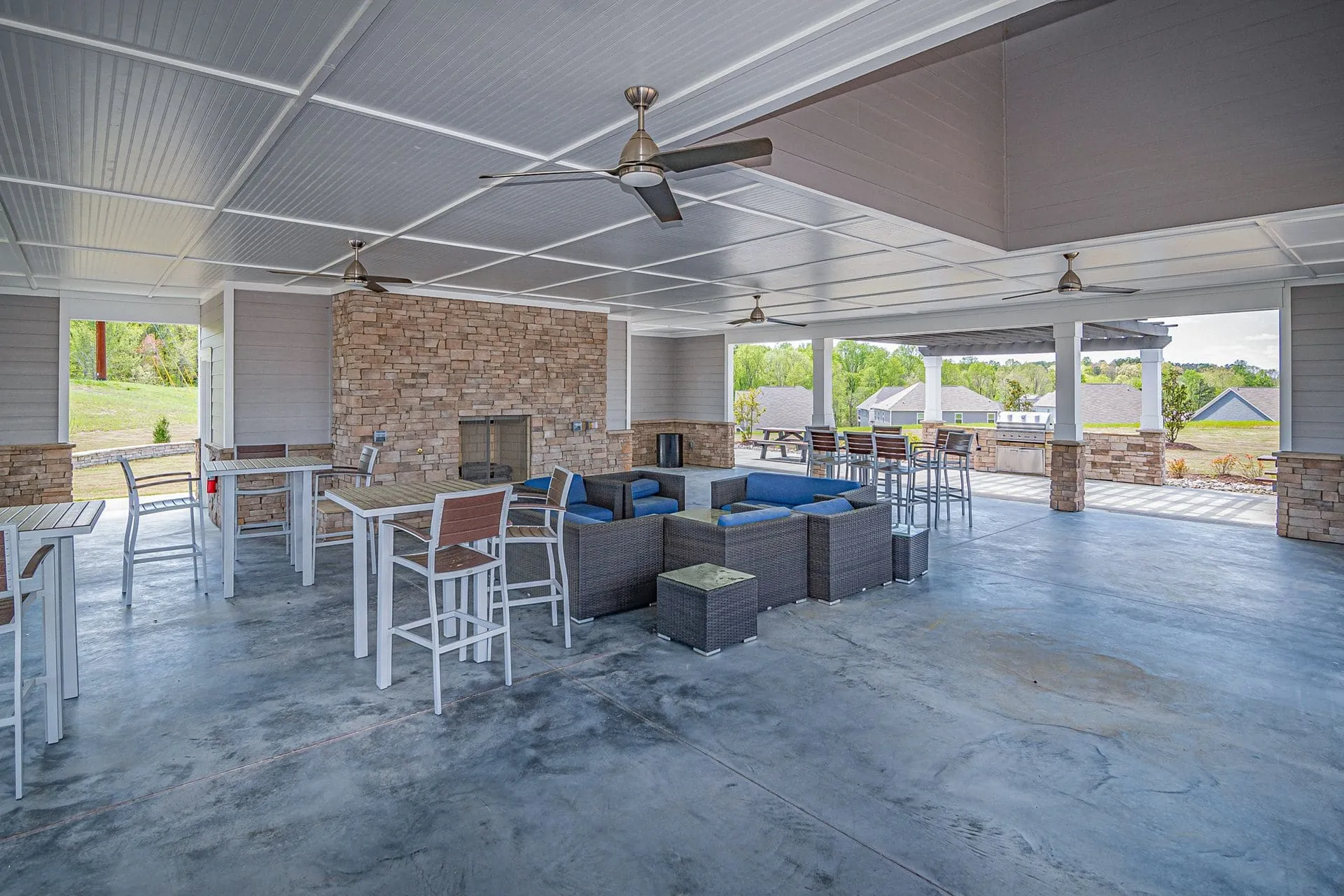Covered patio with a smooth white ceiling and fans, similar to insulated roof panels
